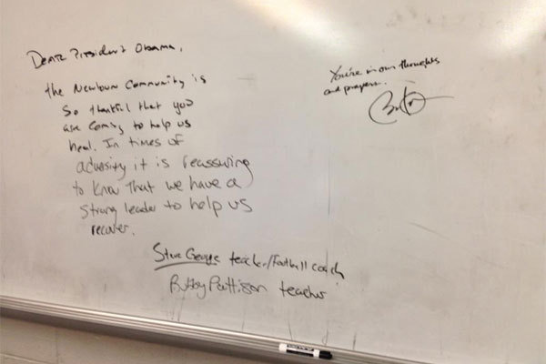 Two faculty members at Newtown High School left a message for President Obama on the football team's whiteboard -- and the president responded.
