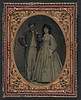 [Unidentified soldier in Union sergeant's frock coat and forage cap with unidentified woman in dress and hat with veil] (LOC) by The Library of Congress