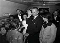 Judge Sarah Hughes administers the oath to Lyndon Johnson aboard Air Force One following the assassination of John Kennedy in 1963