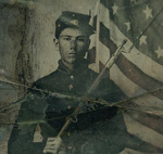Unidentified soldier in Union uniform with bayoneted musket in front of American flag