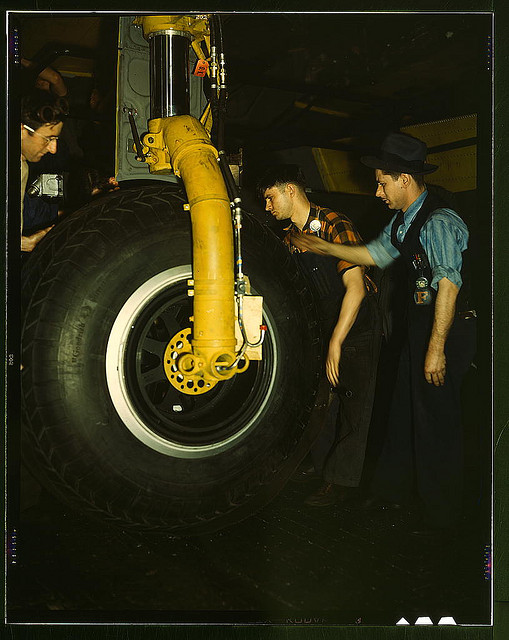 Inspecting of landing wheel of the transport planes at Willow Run (LOC)