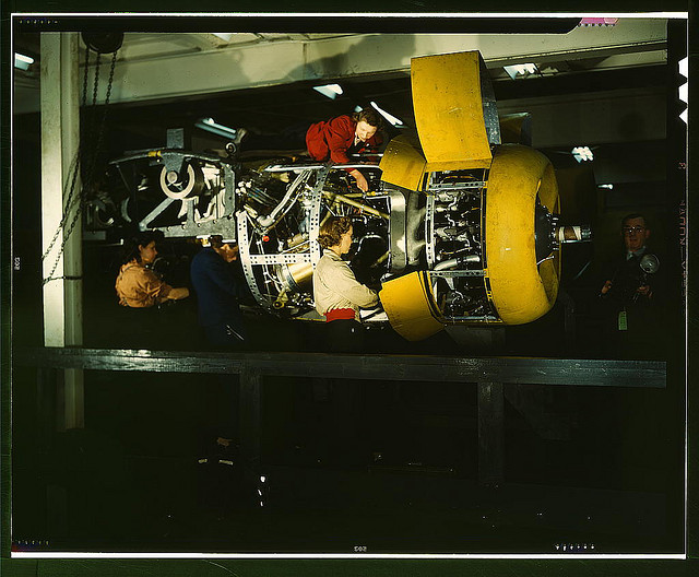 Installing one of the 4 motors on the transport plane at Willow Run (LOC)