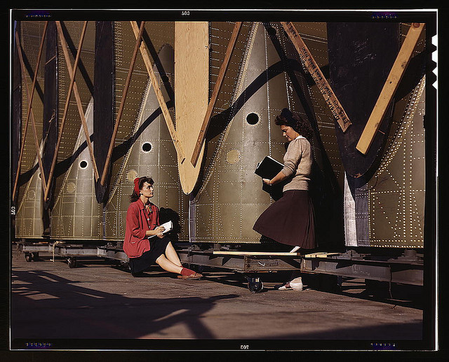 Girl inspectors at the Long Beach, Calif., plant of Douglas Aircraft Company make a careful check of center wings for C-47 transport planes (LOC)