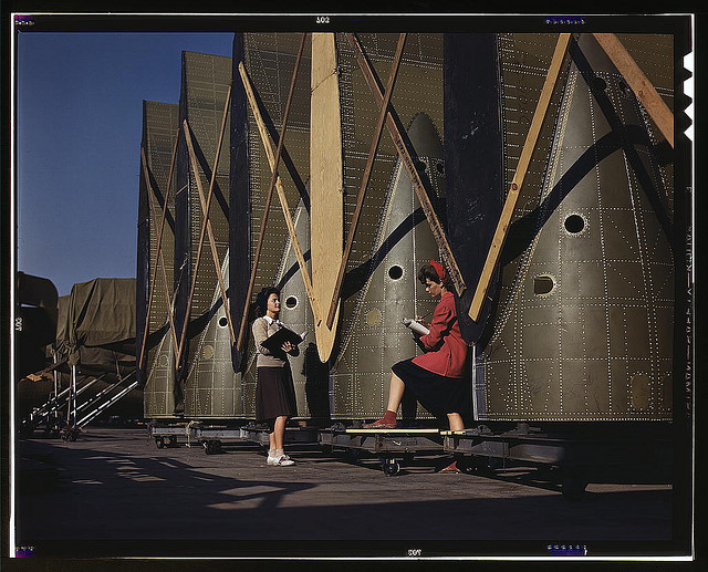 Carefully trained women inspectors check and inspect cargo transport innerwings before they are assembled on the fuselage, Douglas Aircraft Company, Long Beach, Calif. (LOC)