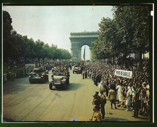 Crowds of French patriots line the Champs Elysees to view Allied tanks and half tracks pass through the Arc du Triomphe, after Paris was liberated on August 25, 1944 (LOC)