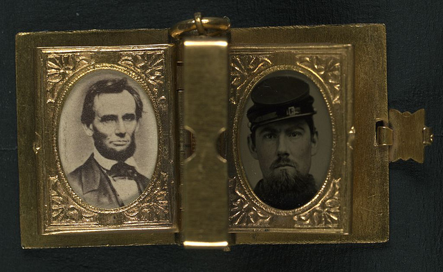 [Two portraits from: Unidentified soldier in Union uniform and forage cap with portraits of Lincoln, Johnson, and an unidentified boy in a book-shaped locket with pages] (LOC)