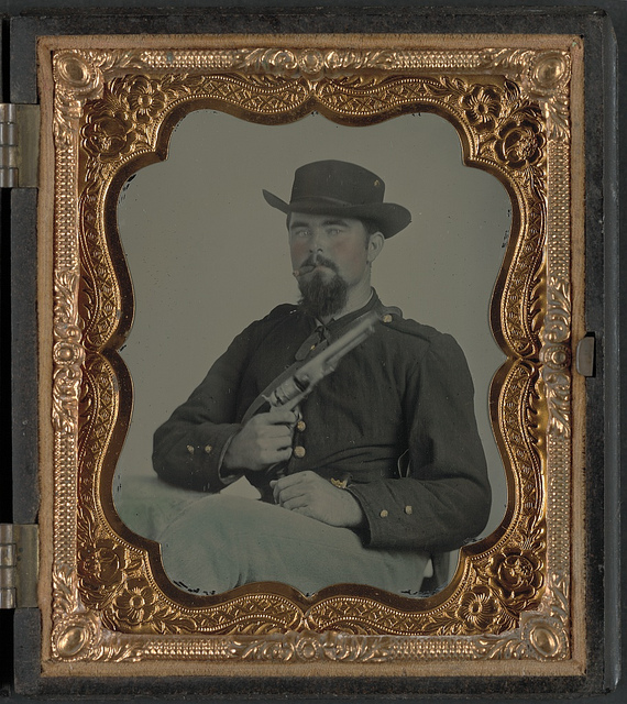 [Private William B. Todd of Company E, 9th Virginia Cavalry Regiment with Colt Army revolver and smoking a cigar] (LOC)