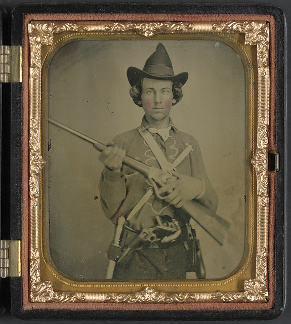 [Unidentified cavalry soldier in Confederate uniform with slant breech sharps carbine, two knives, and two revolvers] (LOC)