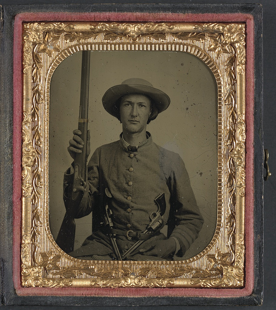[Unidentified soldier in Confederate infantry uniform with model 1842 musket and two Colt revolvers] (LOC)