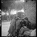 [Toni Frissell, sitting, holding camera on her lap, with several children standing around her, somewhere in Europe] (LOC)