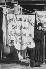 Woman holding a sign for the Scandinavian Suffrage Association of Minnesota