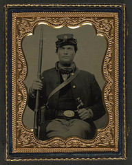 [Unidentified soldier in Union uniform with Company G 16th Regiment forage cap holding bayonet and musket] (LOC)