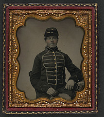 [Unidentified young soldier in Union musician's frock coat with braiding] (LOC)
