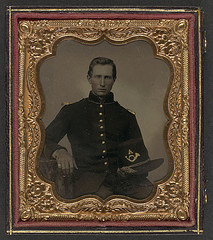 [Unidentified soldier in Union infantry uniform with shoulder scales holding Hardee hat with Company A insignia] (LOC)