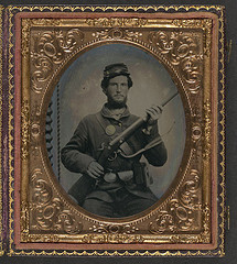 [Unidentified soldier in Union uniform with eagle breast plate, cartridge box, and cap box holding musket with bayonet in scabbard] (LOC)
