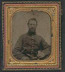 [Unidentified soldier in Union uniform with dual revolvers and sword, wearing eyeglasses] (LOC)