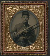 [Unidentified young soldier in Union uniform holding musket with Prescott revolver in belt] (LOC)