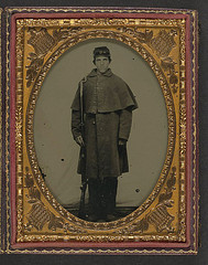 [Unidentified soldier in Union greatcoat with forage hat standing with bayoneted musket] (LOC)