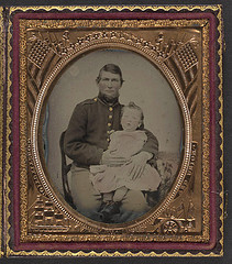[Unidentified soldier in Union uniform holding a young child in his lap] (LOC)