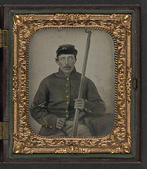 [Unidentified soldier in Union corporal's uniform and forage cap sitting with bayoneted musket] (LOC)