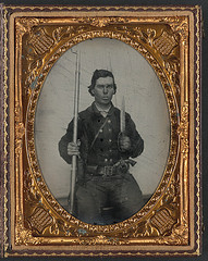 [Unidentified soldier in Confederate uniform with D-guard Bowie knife, musket, and revolver] (LOC)