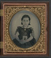 [Unidentified girl in mourning dress holding framed photograph of her father as a cavalryman with sword and Hardee hat] (LOC)