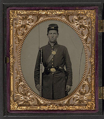 [Isaac Yost of Company C, 118th Regiment Illinois Infantry, standing in uniform with bayoneted musket and revolver] (LOC)