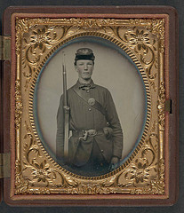 [Corporal Alvin B. Williams of Company F, 11th Regiment New Hampshire Volunteers, with musket and a bayonet in scabbard; dog tag in case] (LOC)