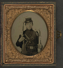[Unidentified soldier in Union uniform holding a U.S. Model 1855 pistol-carbine with attached shoulder stock and a saber] (LOC)