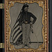 [Unidentified soldier in Union cavalry uniform with Colt Dragoon revolver and sword in front of American flag] (LOC)