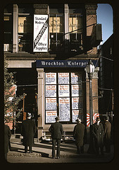 Men reading headlines posted in street-corner of Brockton Enterprise newspaper office, Brockton, Mass. (LOC)