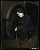 War production workers at the Heil Company making gasoline trailer tanks for the U.S. Army Air Corps, Milwaukee, Wis. Mrs. Angeline Kwint, age 45, an ex-housewife, checking the tires of trailers. Her husband and son are in the U.S. Army (LOC) by The Library of Congress