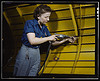 Operating a hand drill at Vultee-Nashville, woman is working on a "Vengeance" dive bomber, Tennessee (LOC) by The Library of Congress