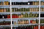 View of shelves filled with jars of preserved produce.