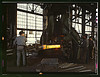 Hammering out a draw bar on the steam drop hammer in the blacksmith shop, Santa Fe R.R. shops, Albuquerque, N[ew] Mex[ico) (LOC) by The Library of Congress