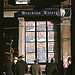 Men and a woman reading headlines posted in street-corner window of Brockton Enterprise newspaper office on Christmas Eve, Brockton, Mass. (LOC)