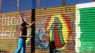 Artists brighten up U.S.-Mexico border fence