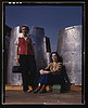 Two assembly line workers at the Long Beach, Calif., plant of Douglas Aircraft Company enjoy a well-earned lunch period, Long Beach, Calif. Nacelle parts of a heavy bomber form the background (LOC) by The Library of Congress