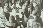 Several well-dressed people gathered at a party