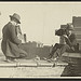 [Two photographers taking each others' picture with hand-held cameras while perched on a roof] (LOC)