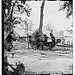 [Gen. Ambrose E. Burnside (reading newspaper) with Mathew B. Brady (nearest tree) at Army of the Potomac headquarters] (LOC)