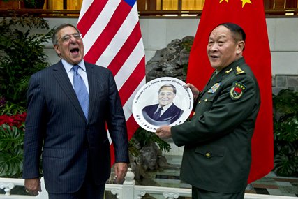 File photo: U.S. Defense Secretary Leon E. Panetta receives a commemorative plate from Gen. Liang Guanglie, Chinese Minister of National Defense, after an official dinner in Beijing, Sept. 18, 2012. 