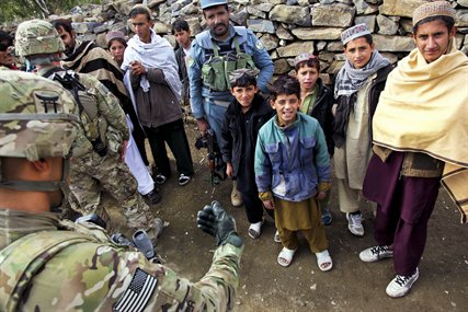 U.S. Army Sgt. Brian Wimer talks with local children in Khoni Kwar village in Afghanistan's Khowst province, Dec. 14, 2012. Wimer is assigned to Company A, 3rd Special Troops Battalion. The U.S. unit and Afghan police tried to gain information on an improvised explosive device located in the area earlier in the week. 