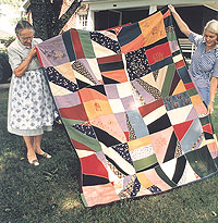 Alma Hemmings and Geraldine Johnson holding a quilt