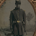 African American soldier in Union uniform and forage cap with bayonet and scabbard
