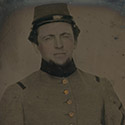 Soldier in Confederate frock coat and kepi