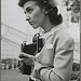 Arlington Cemetery, Arlington, Virginia. A girl taking a picture of the ceremony of laying a wreath on the Tomb of the Unknown Soldier (LOC)