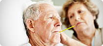 Elderly man rests in bed