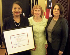 Photograph of NLS director with Illinois librarians, one holding award certificate.