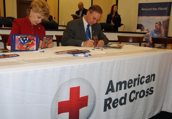 Congresswoman Bordallo signs holiday cards for servicemembers abroad.